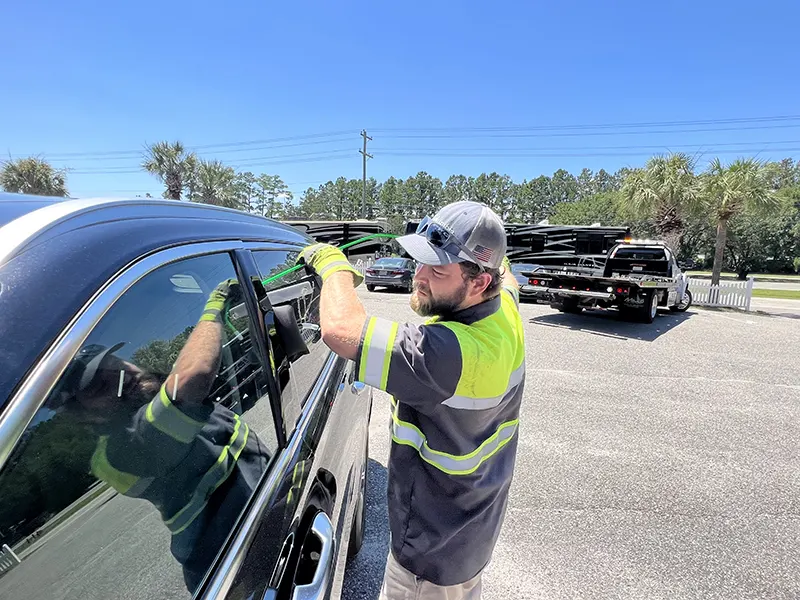 Technician using non-destructive entry tools during a car lockout in Carlsbad, CA