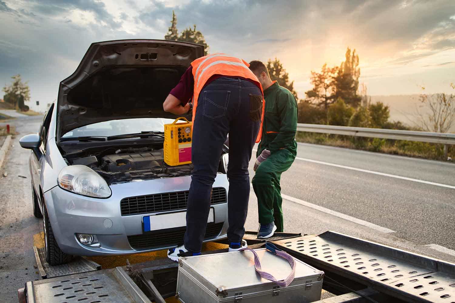 Roadside assistance technicians helping a stranded driver near Carlsbad, CA